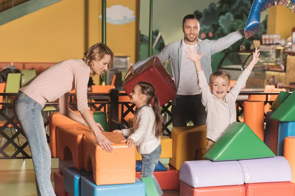 Happy family playing with colorful blocks in entertainment center — Stock Photo