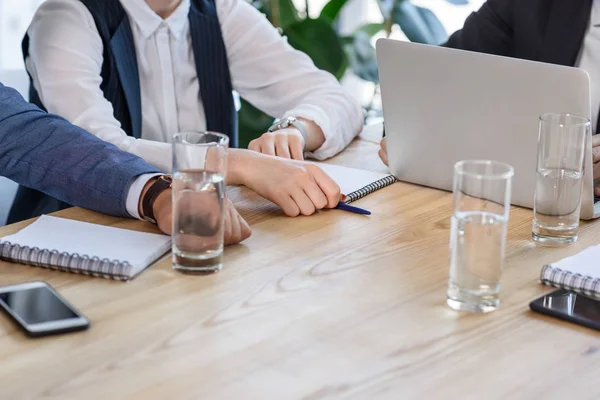 Colleagues writing in notepads during meeting in office — Stock Photo