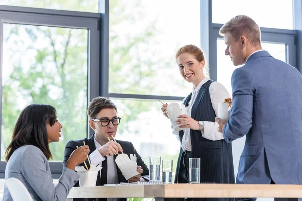 Business team eating chinese food in modern office — Stock Photo