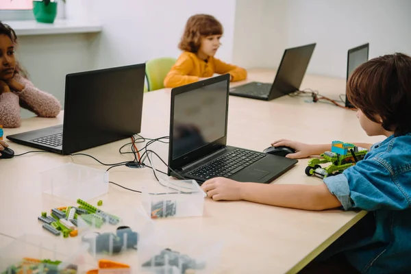 Concetrated kids working with computers on machinery class — Stock Photo