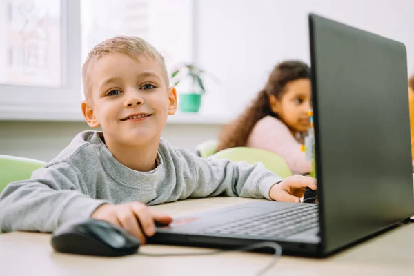 Adorable little kid working with laptop on stem education class — Stock Photo