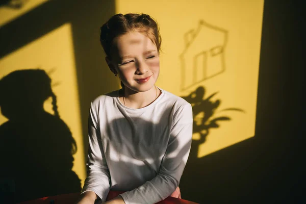 Smiling little child indoor under sunset light — Stock Photo