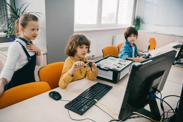 Concentrated children programming robots at class, stem education concept — Stock Photo