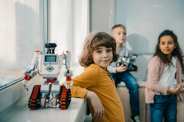 Adorable little schoolboy with diy robot on stem education class — Stock Photo