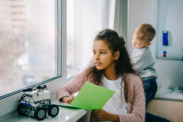 African american schoolgirl with notebook on stem education class — Stock Photo