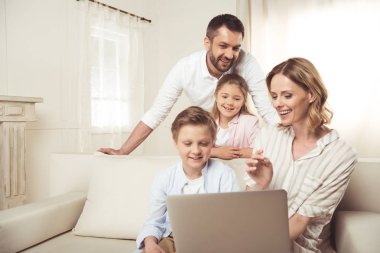 Family using laptop  clipart