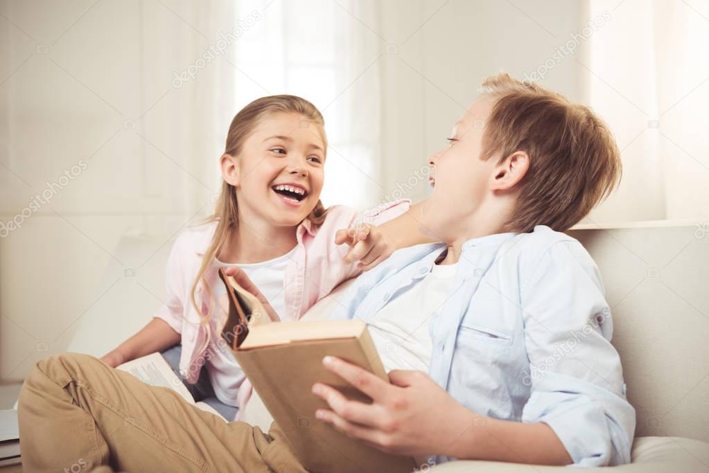 siblings reading book together