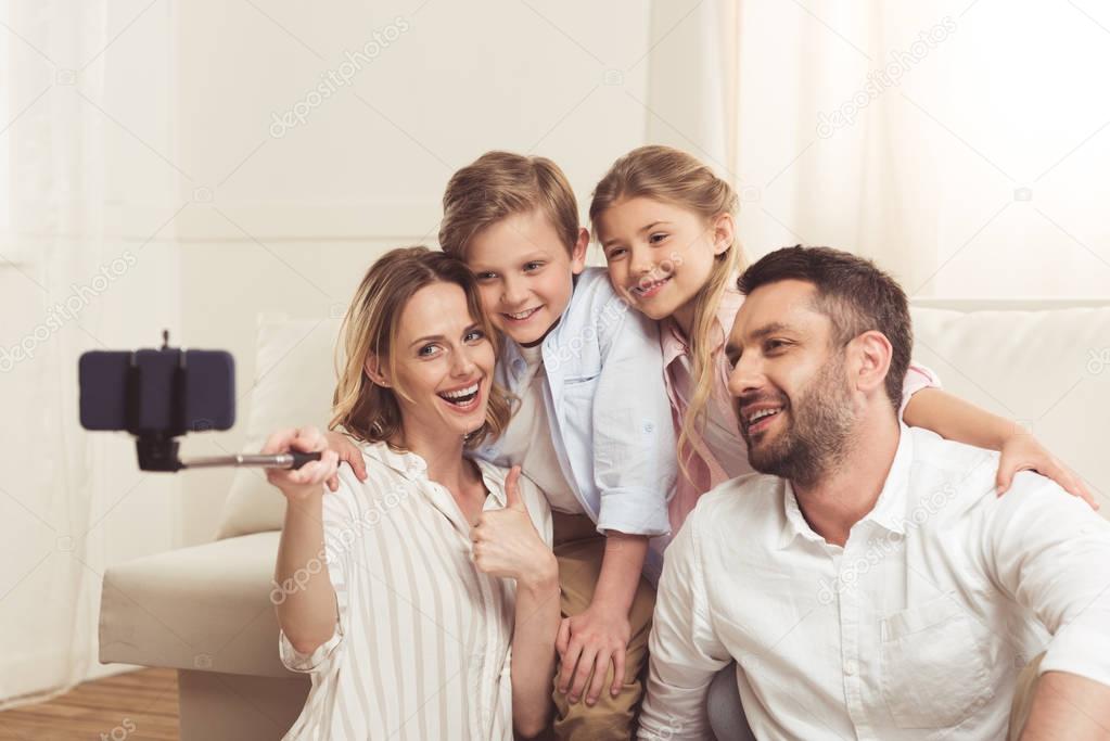 happy family taking selfie on smartphone