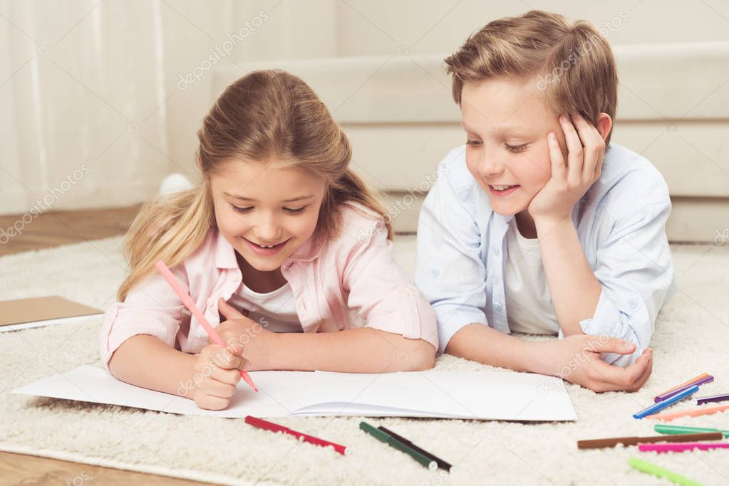 adorable kids drawing pictures at home