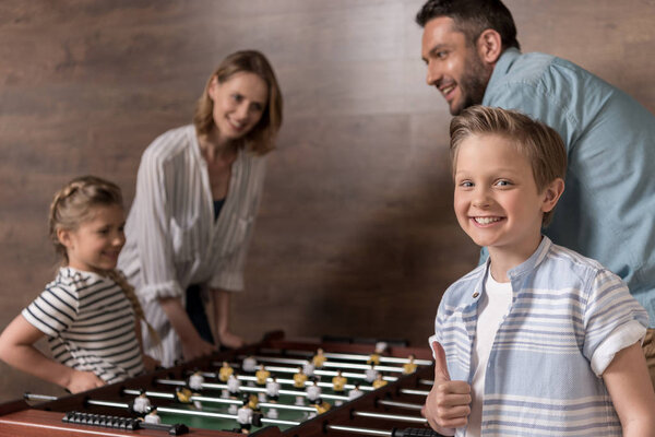 family playing foosball together