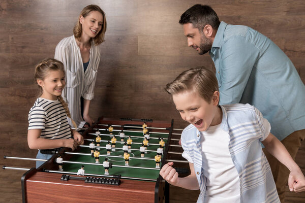 family playing foosball together