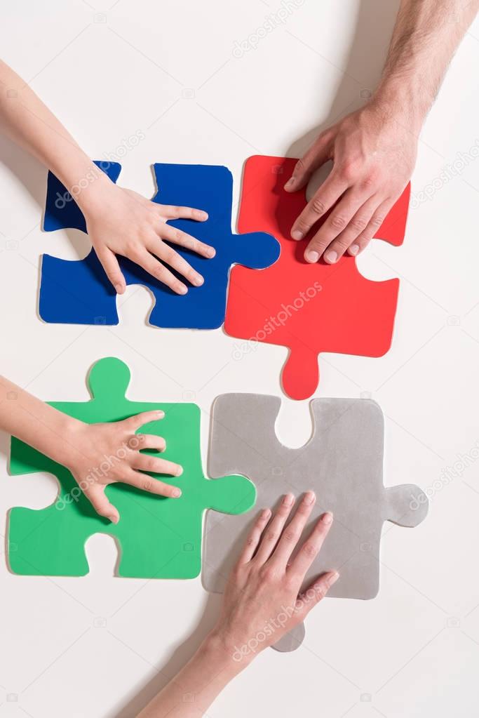 hands on puzzle pieces