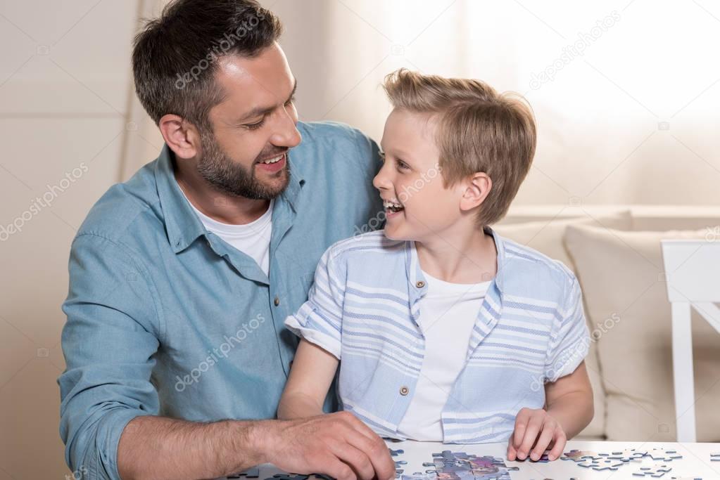 man playing puzzle with son
