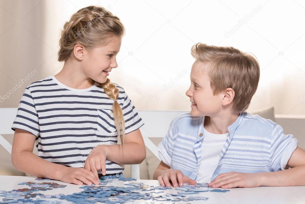 siblings playing with puzzle