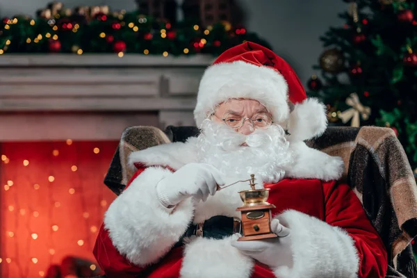 stock image santa claus with coffee grinder