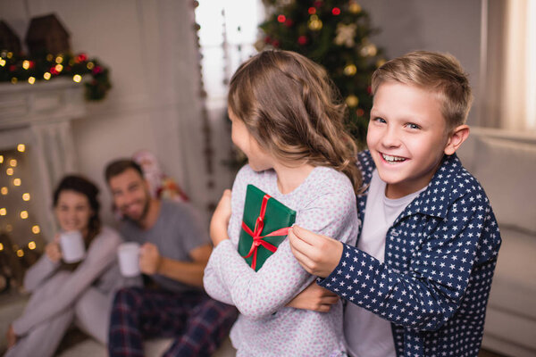 siblings with christmas gift