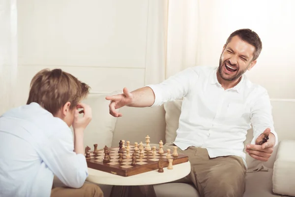 Boy playing chess with father — Stock Photo