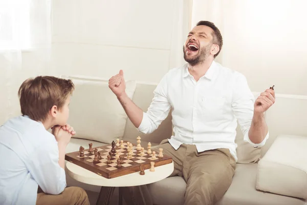 Boy playing chess with father — Stock Photo