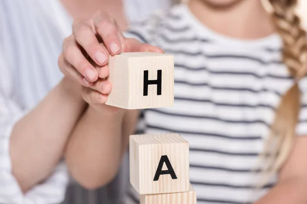 Girl composing word, using cubes — Stock Photo