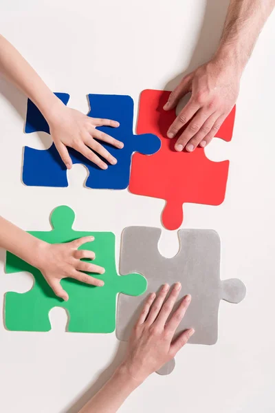 Hands on puzzle pieces — Stock Photo