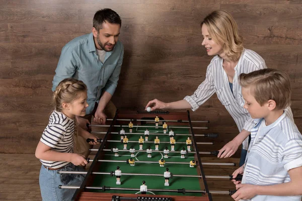 Familia jugando futbolín juntos - foto de stock