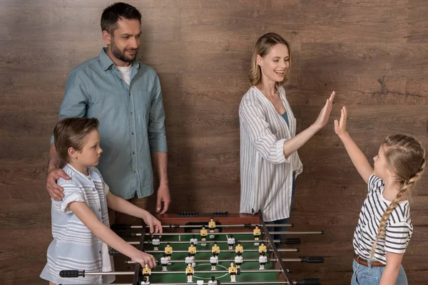 Family playing foosball together — Stock Photo