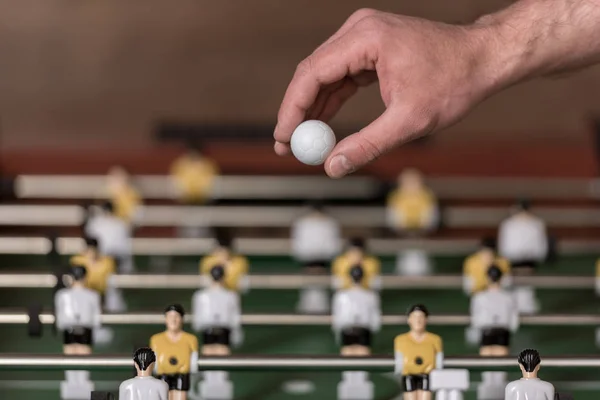 Foosball and hand with ball — Stock Photo