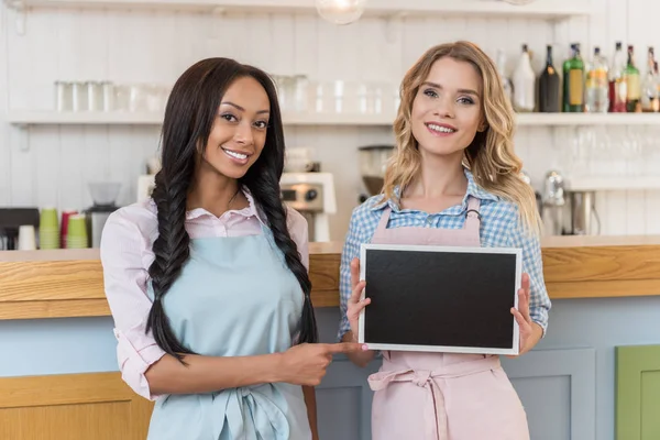 Waitresses with blank board — Stock Photo