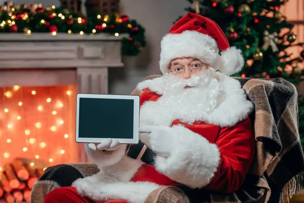 Santa claus presenting tablet — Stock Photo