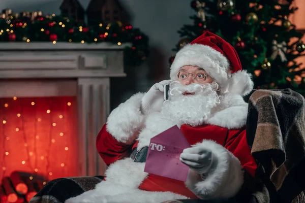 Santa talking on smartphone — Stock Photo