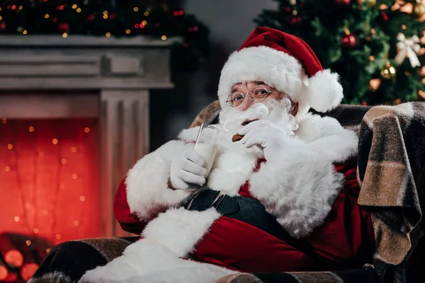 Santa with cookies and milk — Stock Photo