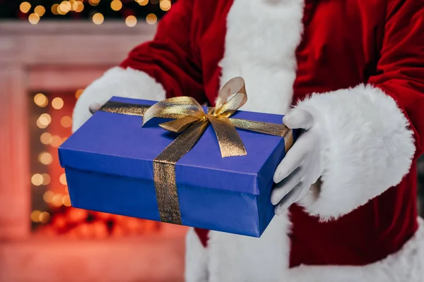 Santa holding gift box — Stock Photo