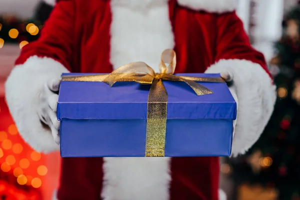 Santa holding gift box — Stock Photo