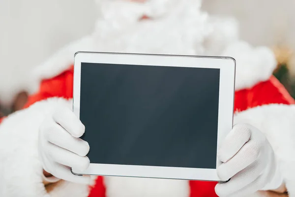 Santa claus presenting tablet — Stock Photo