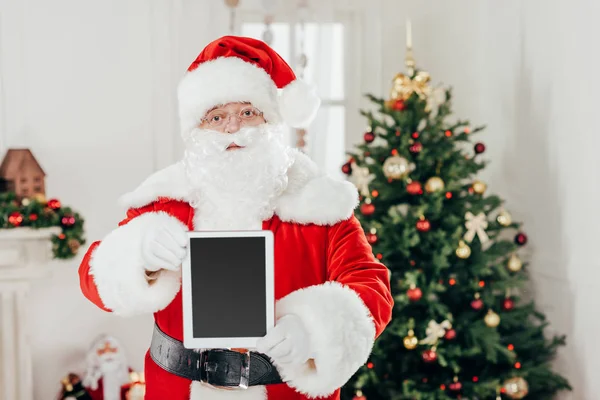 Santa claus presenting tablet — Stock Photo