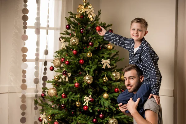 Family decorating christmas tree together — Stock Photo