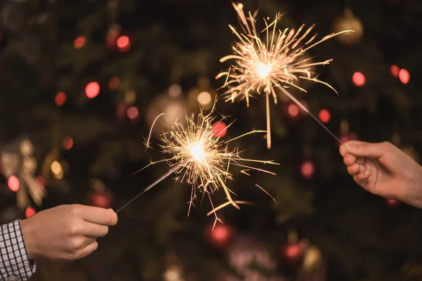 Hands holding sparklers — Stock Photo