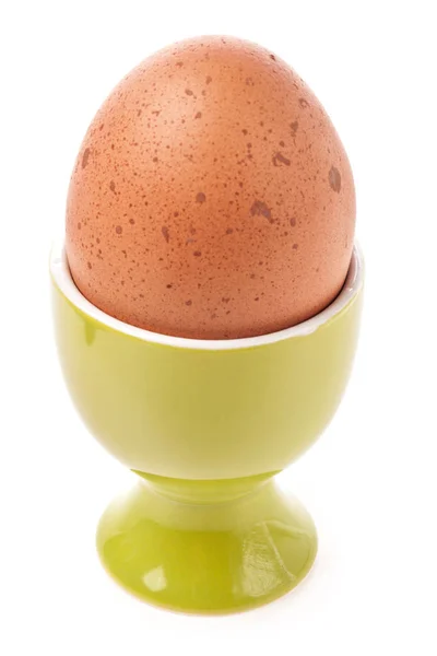 Egg in egg cup isolated on white — Stock Photo, Image