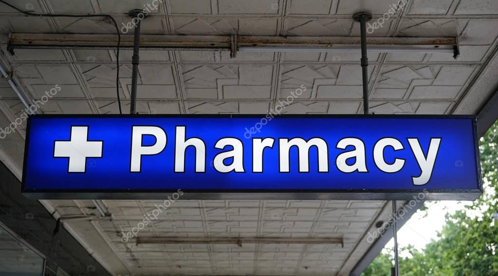 Unspecified universal Pharmacy neon sign above the entrance to the chemist drug store