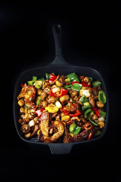 Fried meat and vegetables in pan — Stock Photo, Image