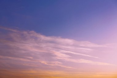 Pembe bir günbatımının ya da şafağın parlak bir fotoğrafı var. Batan güneşin ışınlarında parlak bulutlar. Akşam gökyüzünde uçakların iç organları.