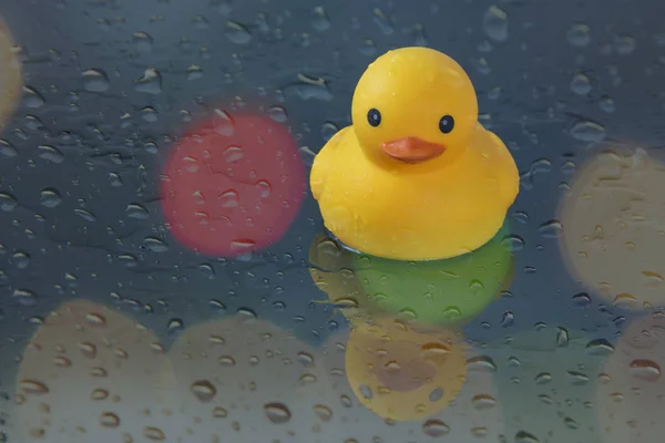 Cute yellow rubber duck isolated over light bokeh background