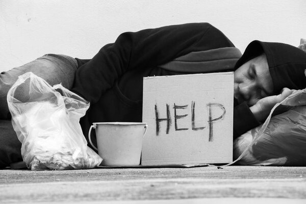Homeless person sleep on sidewalk of the street