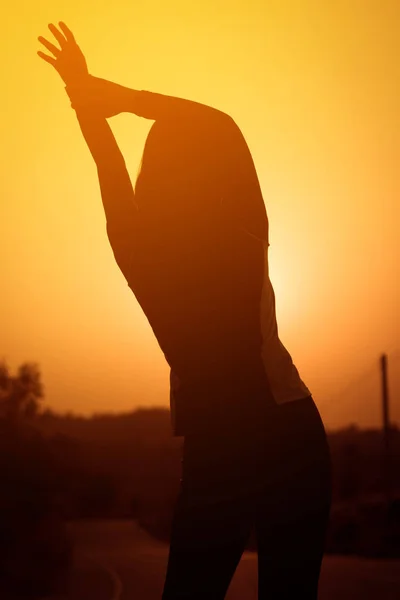 Mujer ejercitando al aire libre al atardecer — Foto de Stock