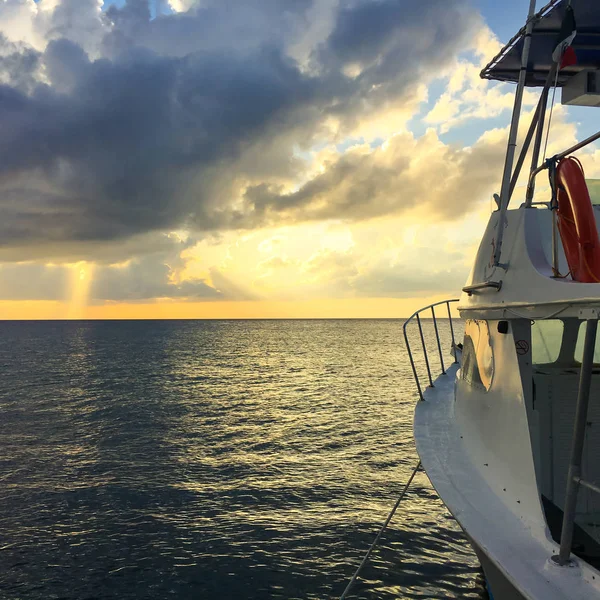 Sunset on ocean with boat.