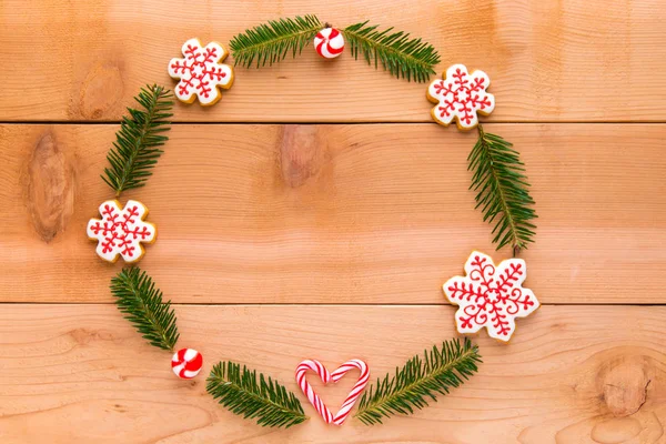 Couronne de Noël avec biscuits faits maison sur table en bois . — Photo