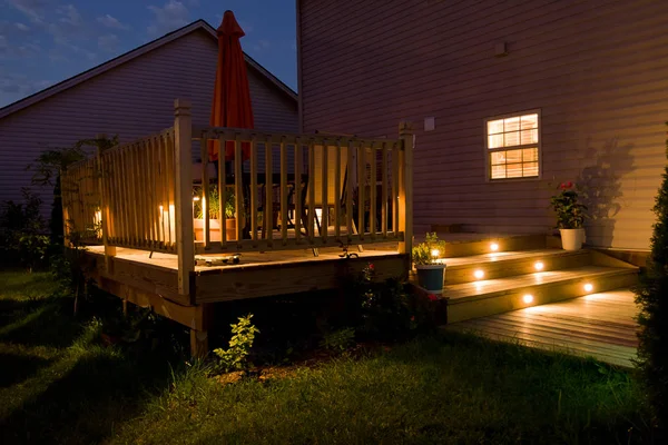 Wooden deck and patio of family home at night. — Stock Photo, Image