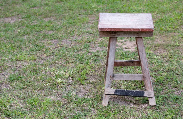 Alter Holzstuhl auf dem Rasenplatz im Freien — Stockfoto