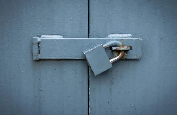 Iron gate with lock, locked metal doors — Stock Photo, Image