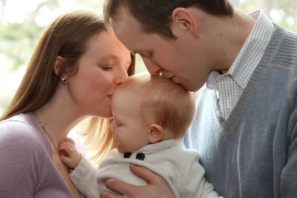 Parents kiss son